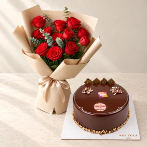 Passionate Scarlet red roses and eucalyptus beside a round Nutella chocolate cake